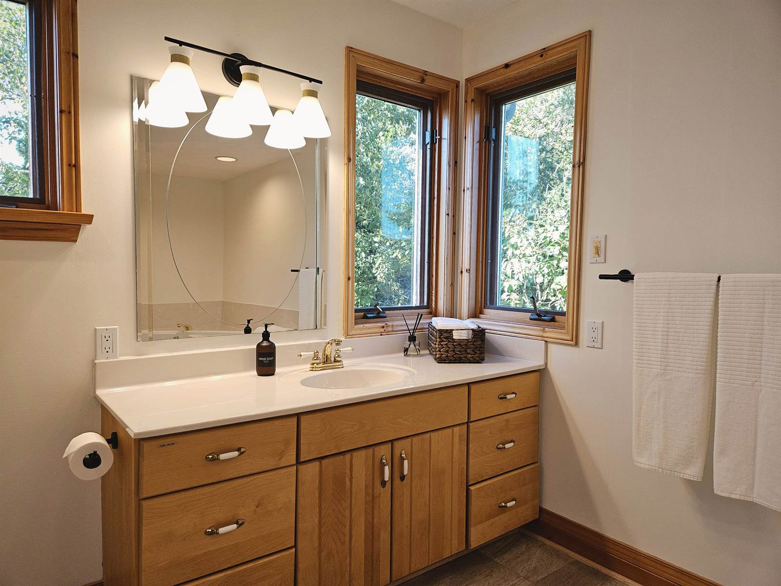 Main bathroom at Casolena with corner windows over the vanity