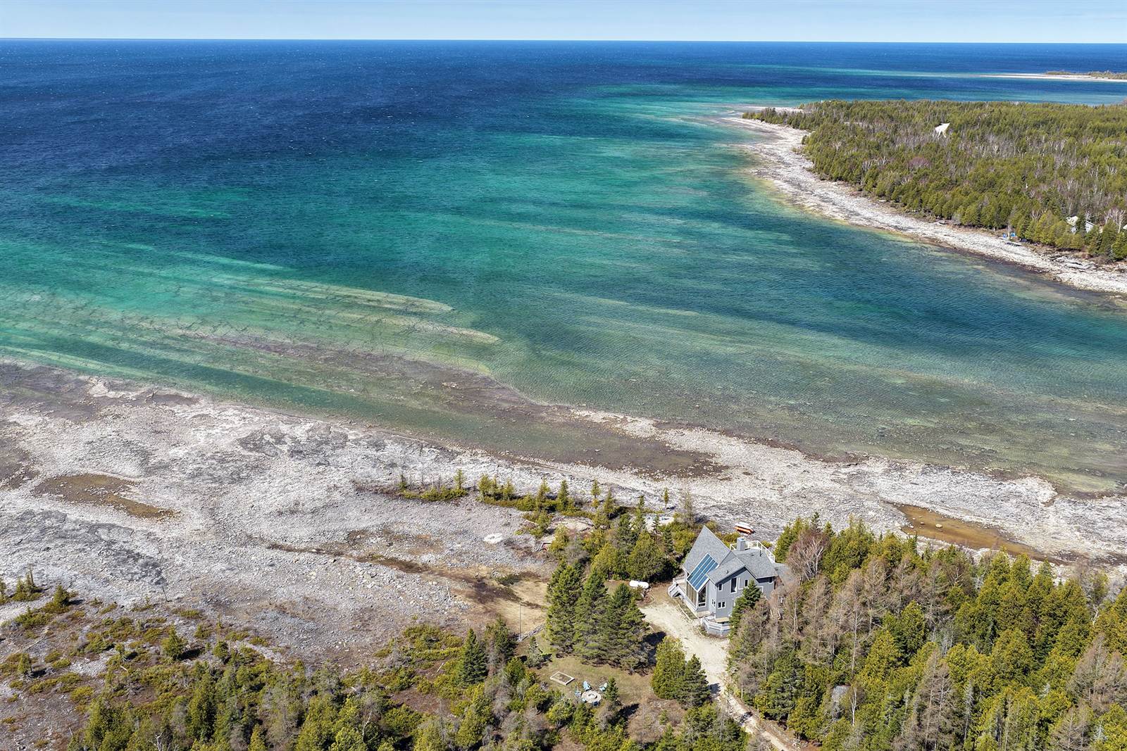 Aerial of the turquoise bay and long limestone shoreline